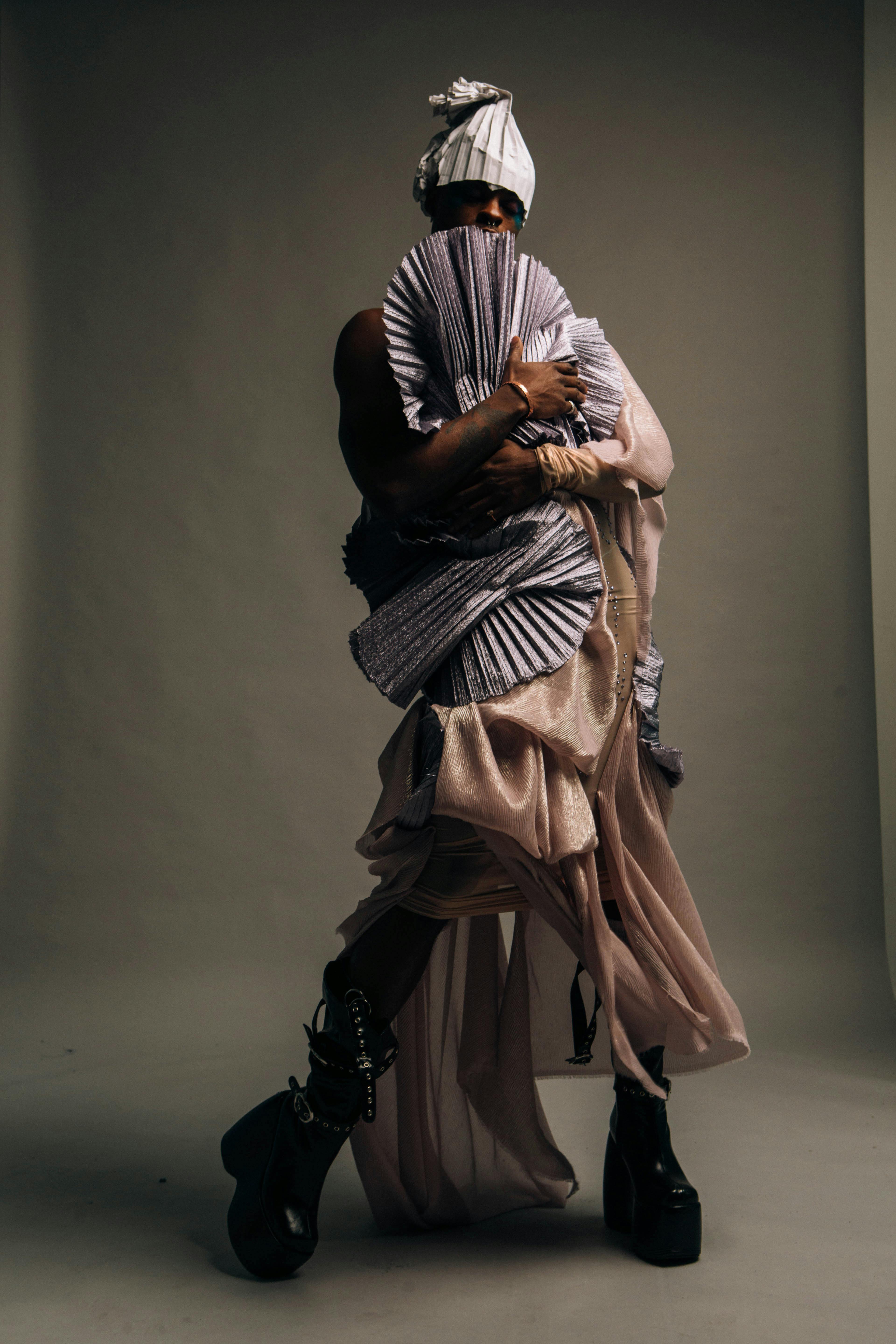 A picture taken for the logic magazine. A figure is clad in garb against a semigray dark background