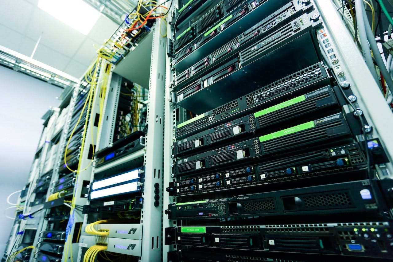 A close-up shot of racks of servers connected by various cables inside a data center